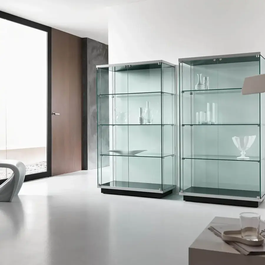 Distinguished Tonelli Design showcase crafted from transparent tempered glass with a black lacquered wood base and silver metal frame