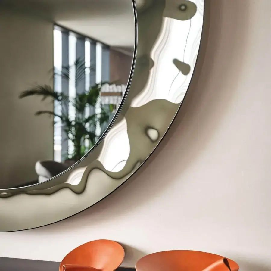 Elegant Cattelan Italia Cosmos mirror with irregularly contoured mirrored glass and bush-hammered fumé finish