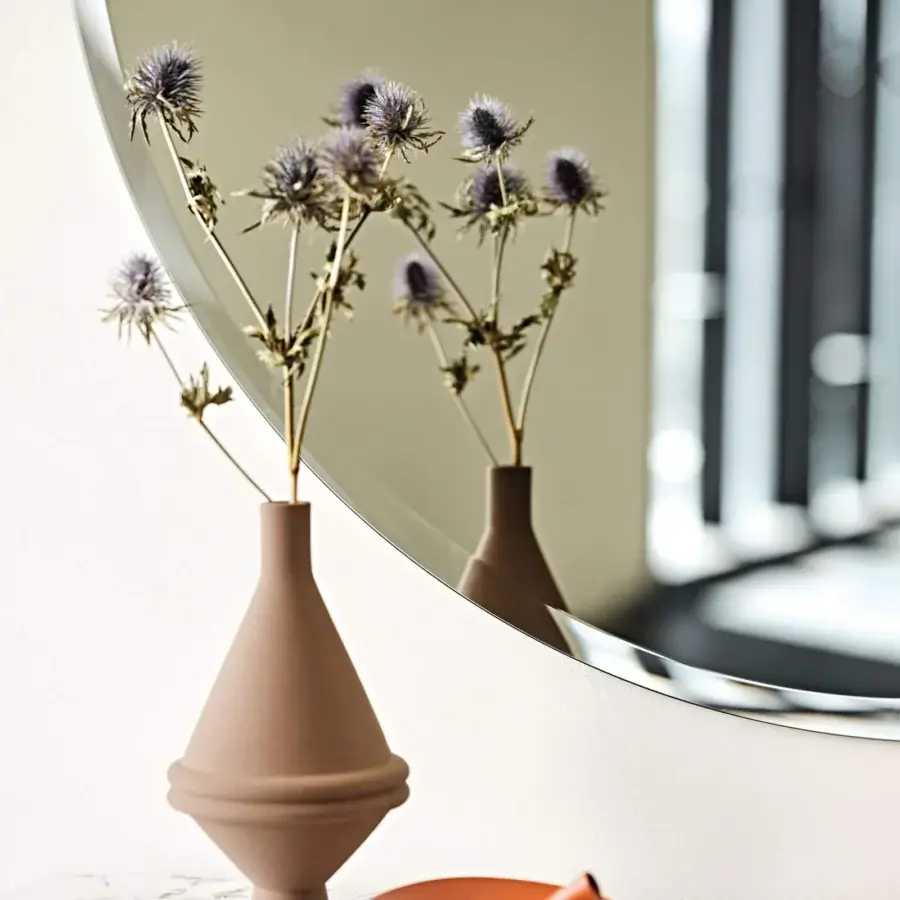 Captivating Cattelan Italia Hawaii mirror with round form and meticulously worked mirrored edge reflecting light