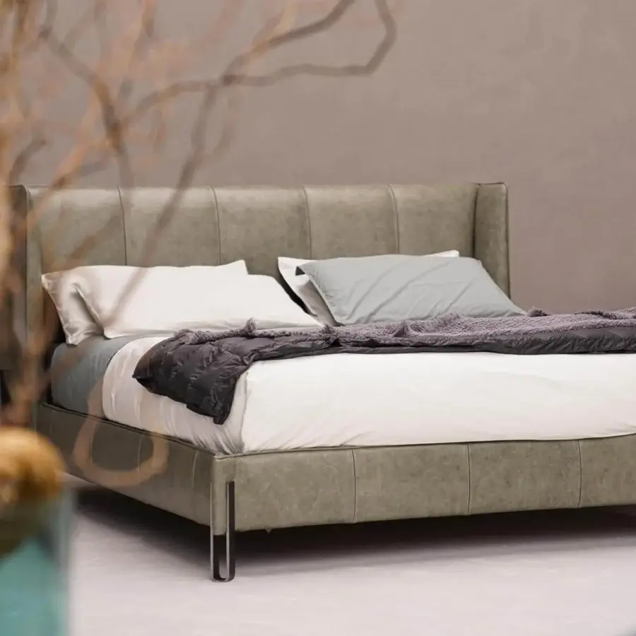 Distinguished Arketipo Big Night bed with angular metal clasp and muted gray-green textile upholstery with a matte finish