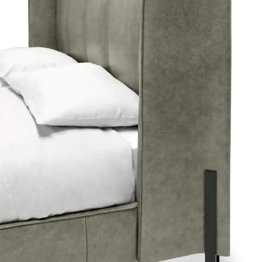 Superior Arketipo Big Night bed with folded headboard and dark finished metal clasps in medium gray upholstery