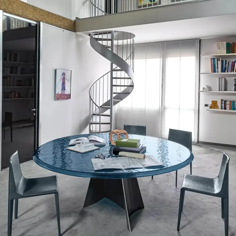 Captivating Arketipo Avalon table with rippling blue glass top and dynamically sculpted dark matte iron base