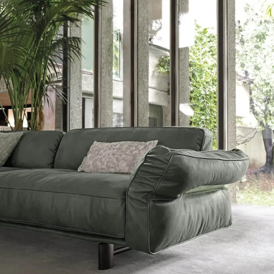 Distinguished Arketipo Close to Me sofa with dark green textile upholstery and wraparound leather straps with metal clasps