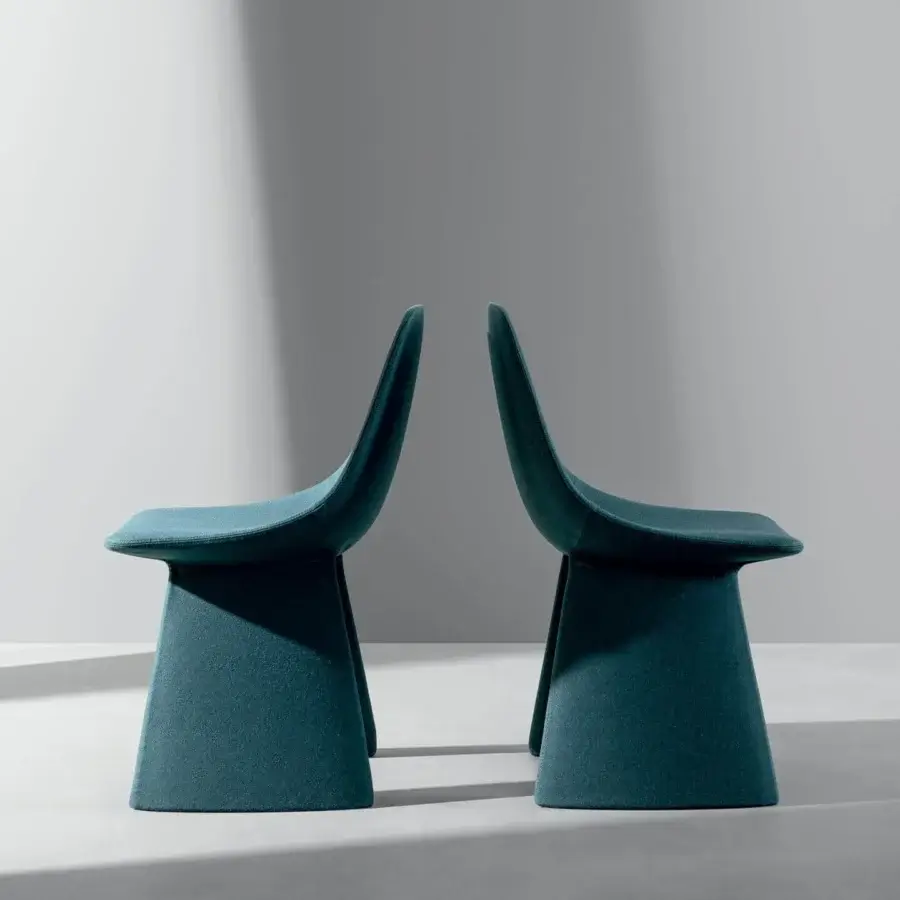 Distinguished Bonaldo Agea chair upholstered in muted teal fabric with matte finish and monolithic steel base