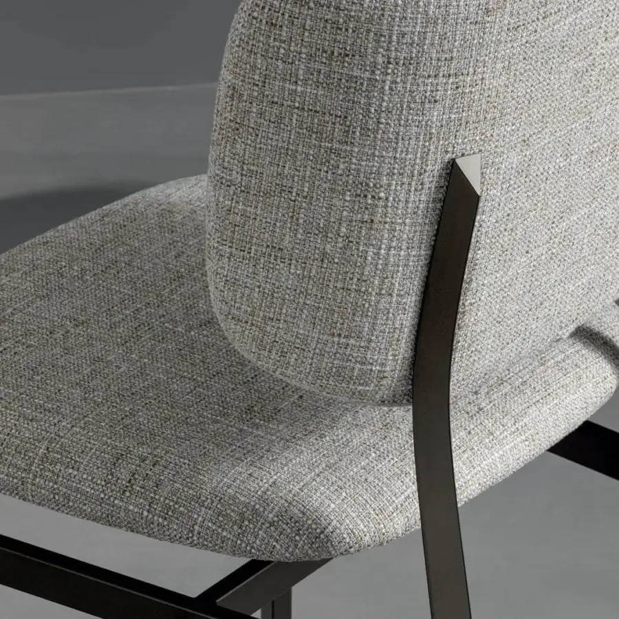 Elegant Bonaldo Noor chair with comfortably padded light gray textured fabric and dark finished steel structure