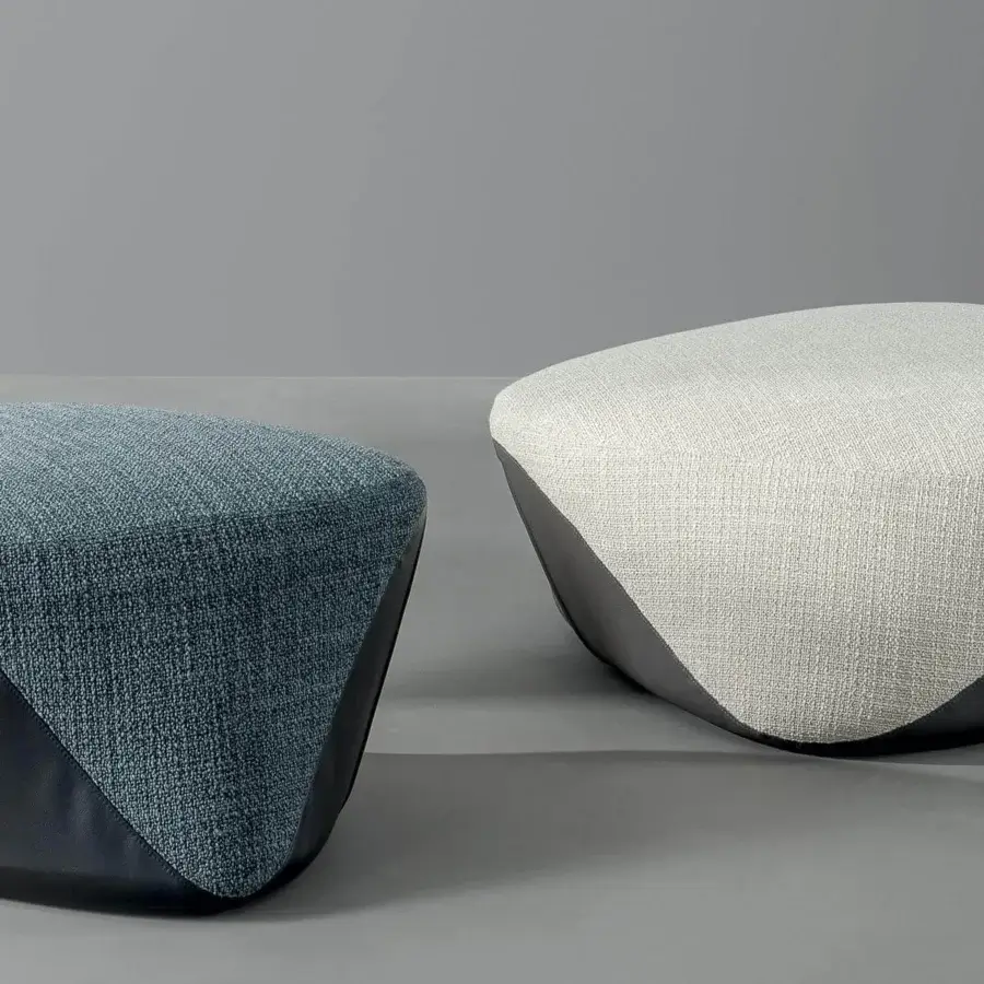 Elegant Bonaldo Seki ottoman crafted in light beige fabric with a darker curved base showcasing bi-cover design