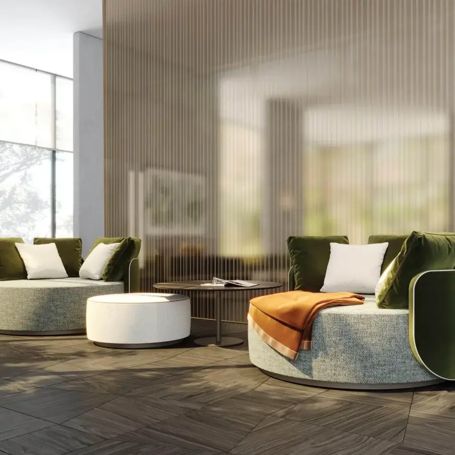 Elegant Reflex Hug chaise lounge with a heathered gray fabric seat and smooth olive green backrest built with a swivel plinth base