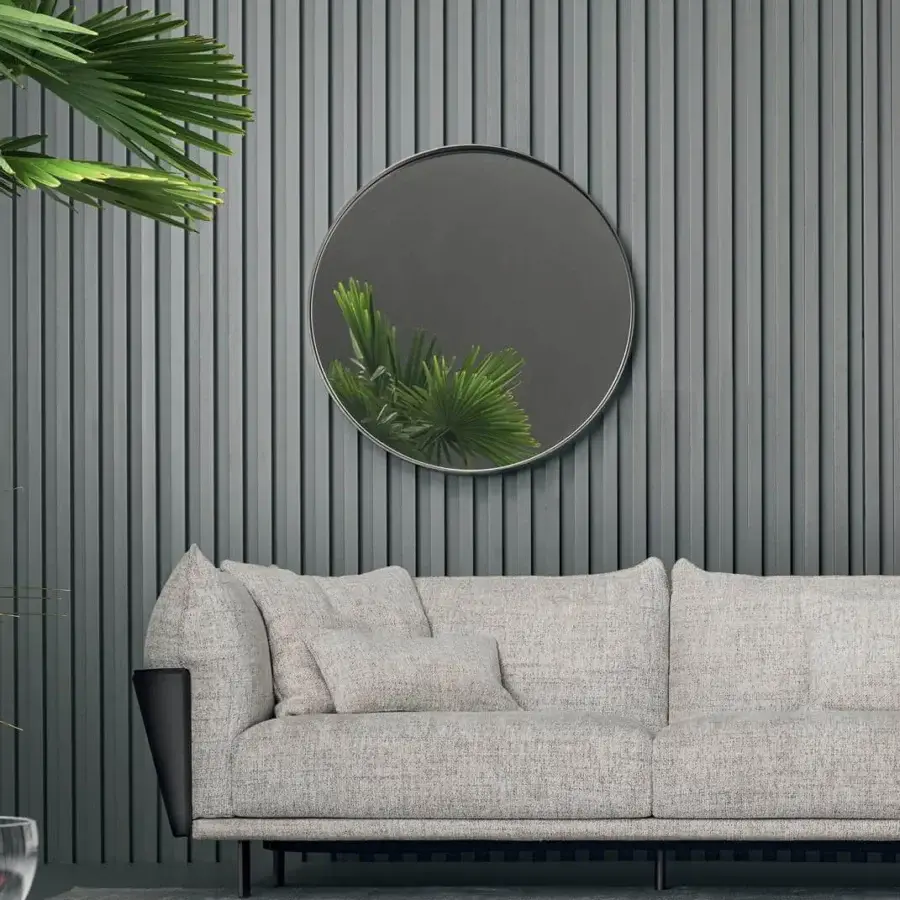 Elegant Bonaldo Adone mirror with a round silhouette and slim dark metal rim, exhibiting a subtle matte finish
