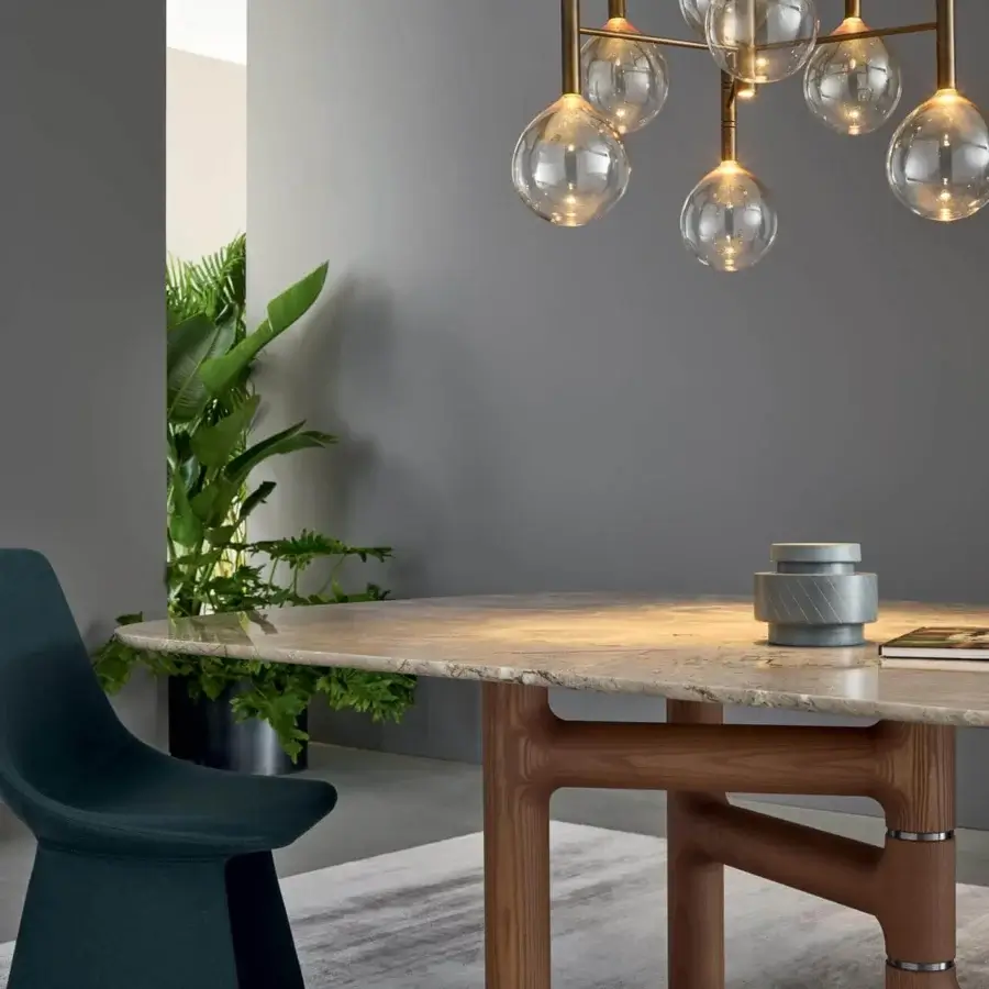 Elegant Bonaldo Pivot table with light beige ceramic oval top and asymmetric solid wood base crafted with refined metal inserts