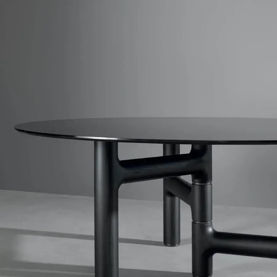 Distinguished Bonaldo Pivot table with a round black top and refined metal inserts within a solid wood base