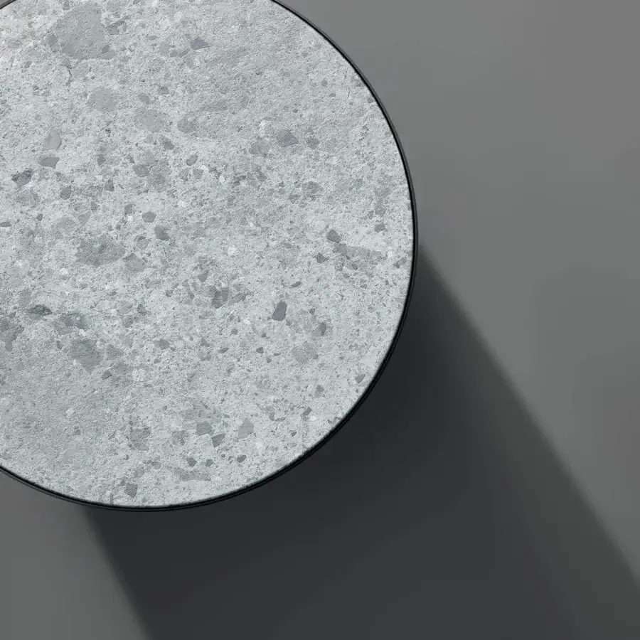 Distinguished Bonaldo Pisa coffee table with recessed terrazzo-like top in shades of gray and blue, exhibiting a smooth matte finish