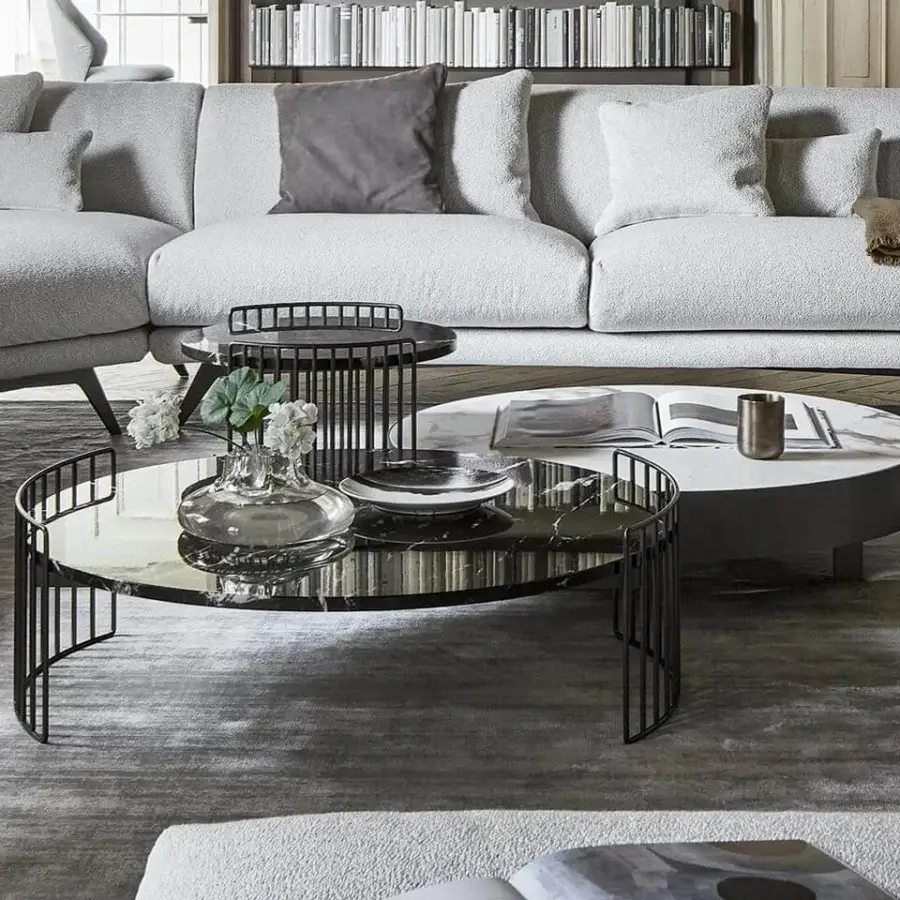 Captivating Bonaldo Harpe coffee table with dark-finished metal base encircling a round glass tabletop exhibiting a marble-like pattern