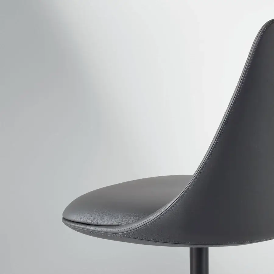 Superior Bonaldo Itala chair with organic silhouette upholstered in dark gray eco-leather and metal four-spoke swivel base