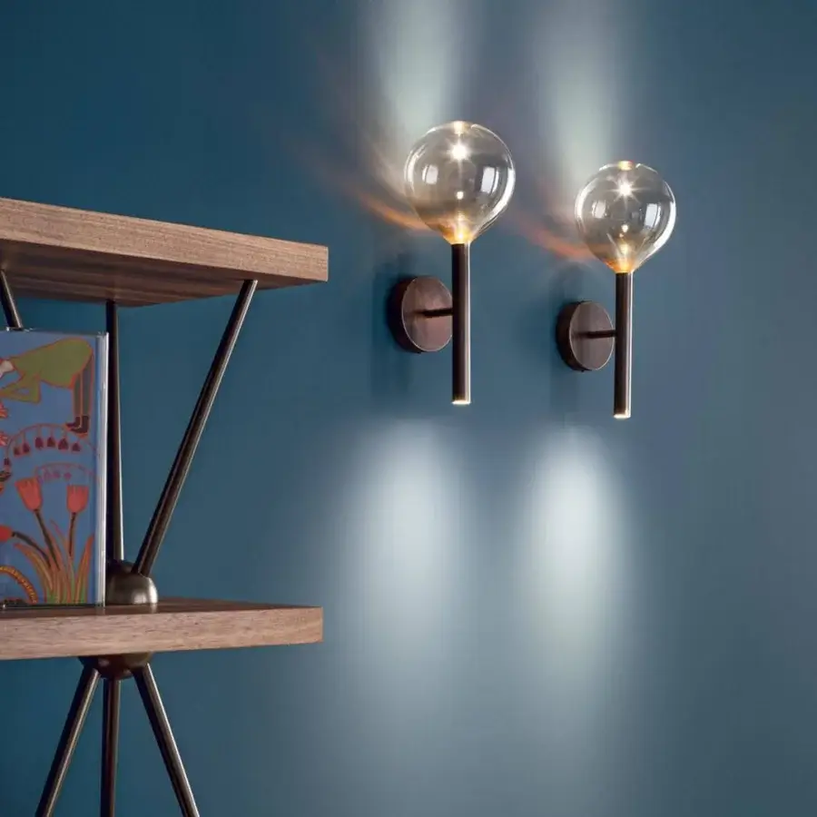 Refined Bonaldo Sofi wall lamp with warm amber borosilicate glass and burnished brass cylinder