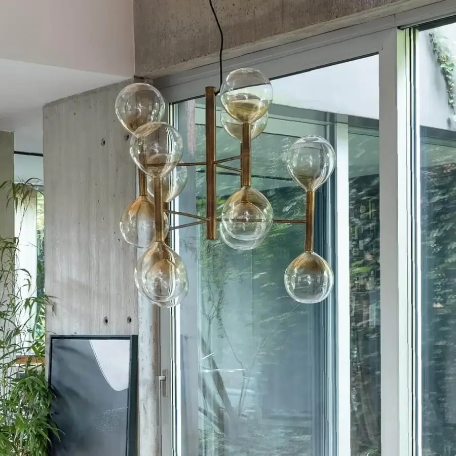 Elegant Bonaldo Sofi suspension lamp with thirteen warm amber borosilicate glass globes and burnished brass cylinders