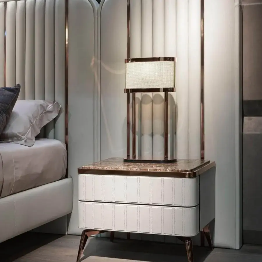 Distinguished DV Home Collection Hollywood nightstand with leather layering and glossy stone-like top built with bronze stainless steel accents