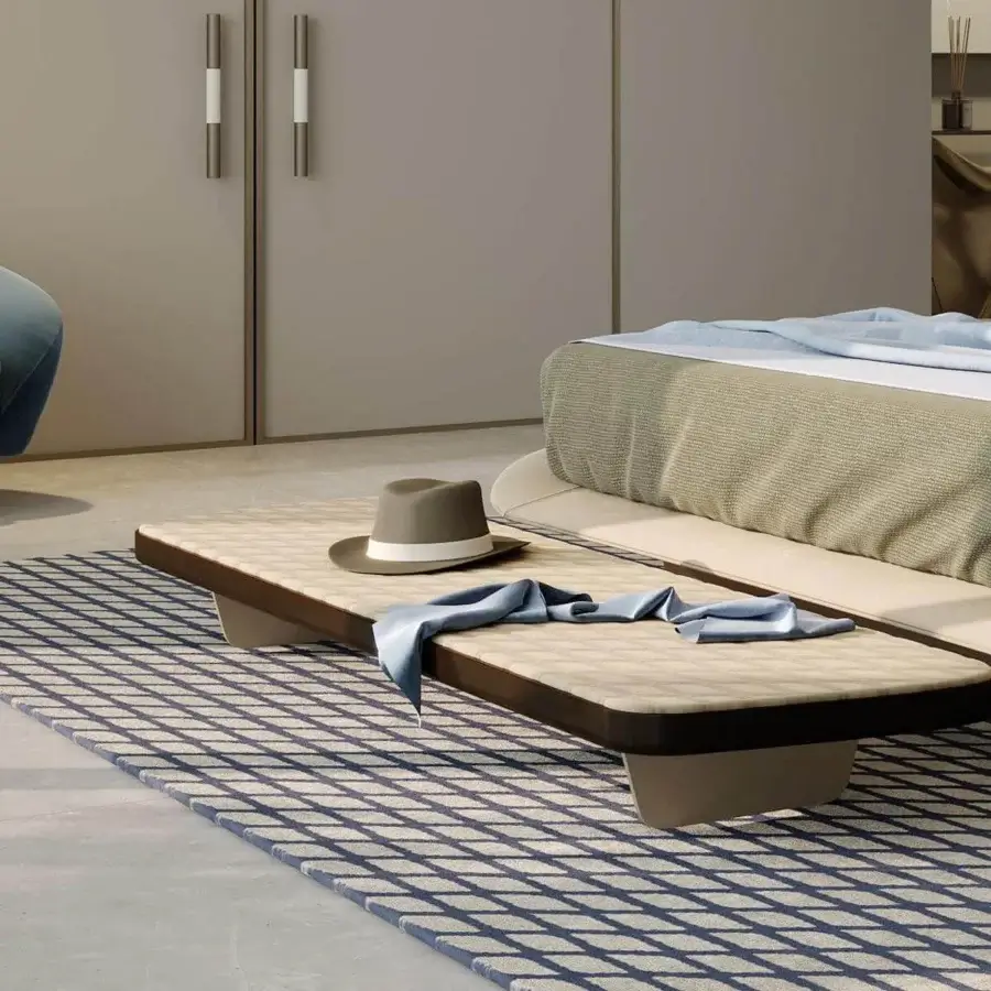 Superior Reflex Segno ottoman with quilted light beige leather and dark brown trim, supported by metal legs