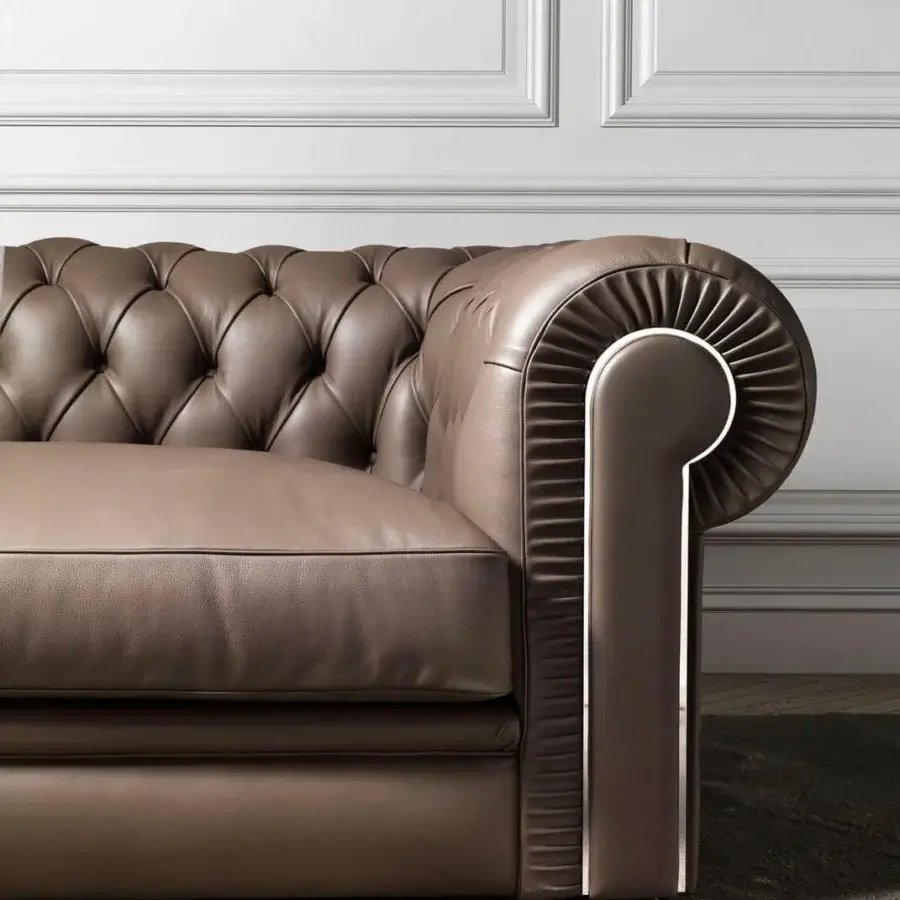 Superior DV Home Collection King Chester sofa with leather upholstery, tufted backrest and stainless steel accents in a matte finish