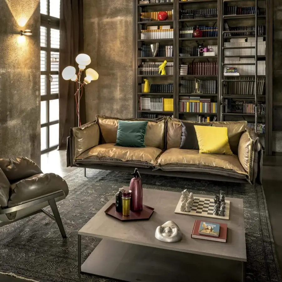 Distinctive Arketipo Auto-Reverse sofa with two-sided cover in textured gold-brown leather and deep teal fabric, highlighted by a prominent zip detail