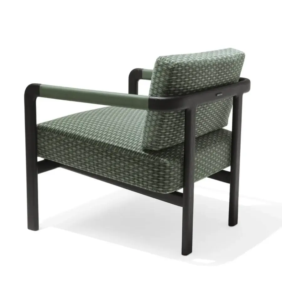 Elegant Giorgetti Montgomery lounge chair with solid ash structure and woven green and white textile upholstery displaying a dark finish
