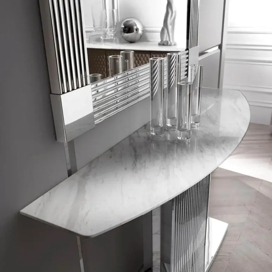 Distinguished DV Home Collection Windsor mirror with beveled glass and sleek stainless steel frame, paired with a marble-like console table built with striated silver metal