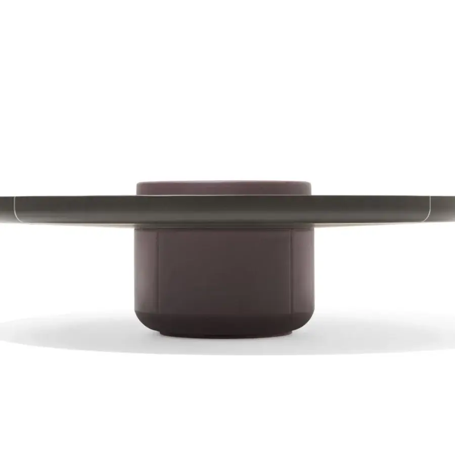 Innovative Giorgetti Ray coffee table with a round silhouette and muted purplish-brown leather storage structure supporting a solid ash top