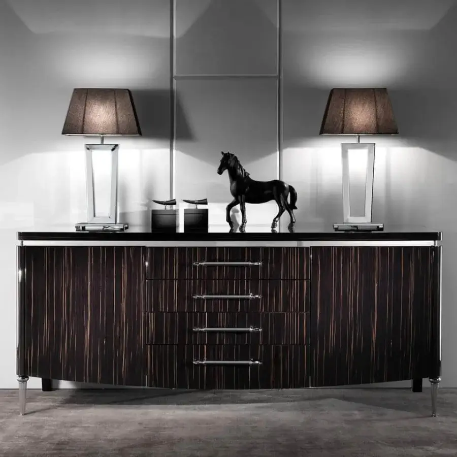 Elegant DV Home Collection Deco table lamp with a geometric silhouette crafted in metal and dark toned fabric with a glossy finish