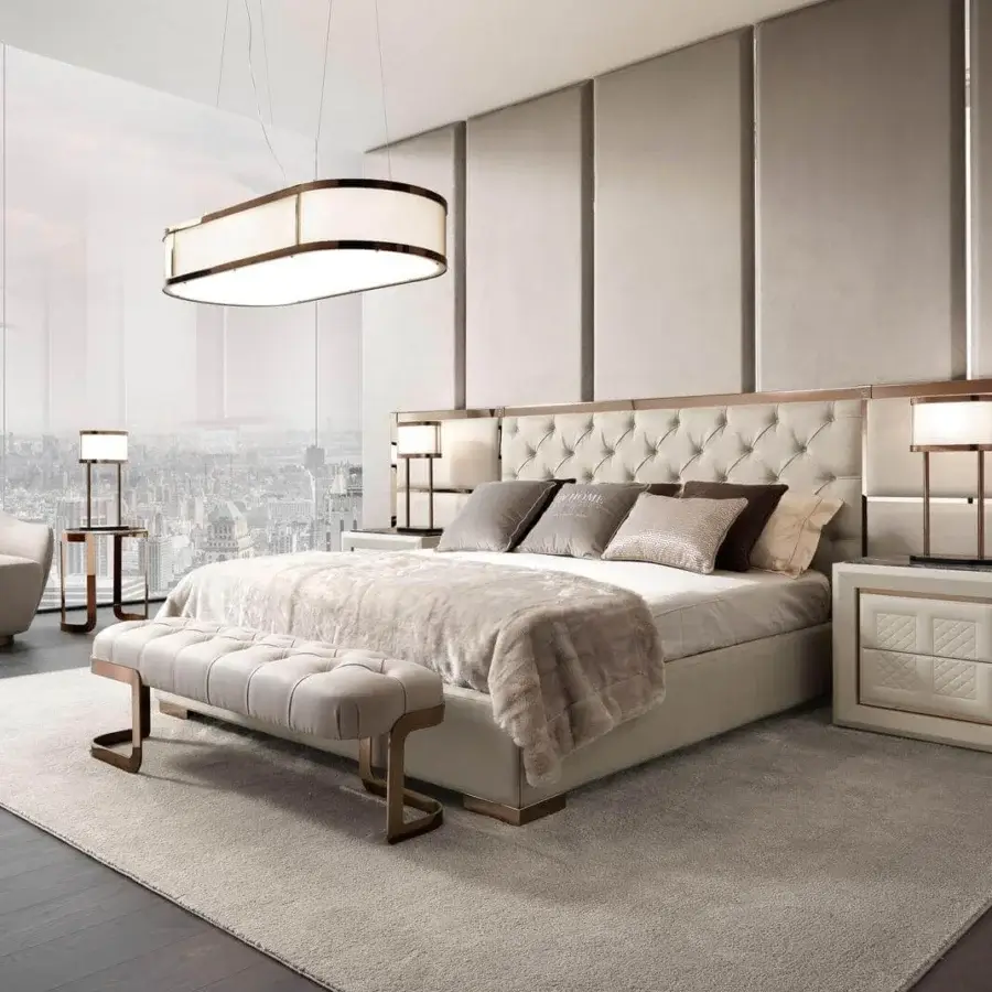 Exclusive DV Home Collection Chelsea bed with plush light beige textile and refined metal trim detailing