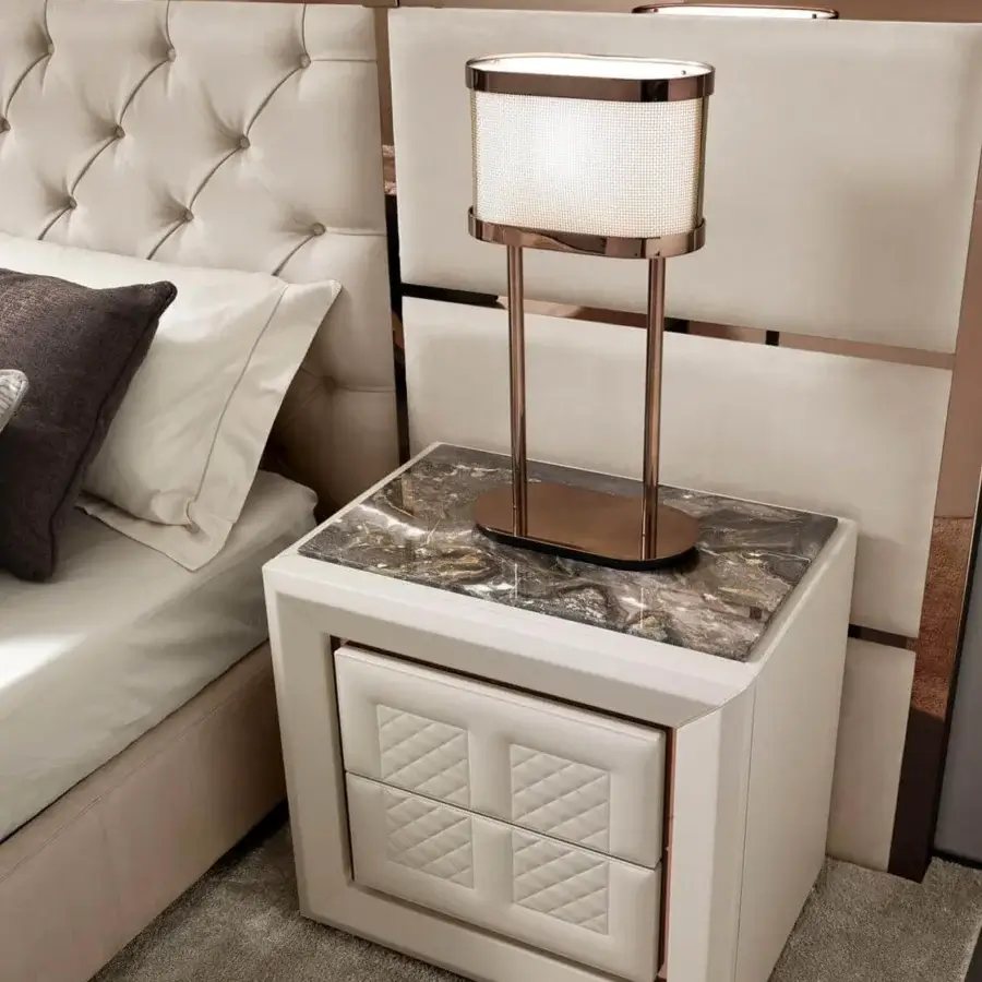 Exceptional DV Home Collection Chelsea bed with light beige fabric upholstery and rose gold-colored metal accents framing tufted stitching