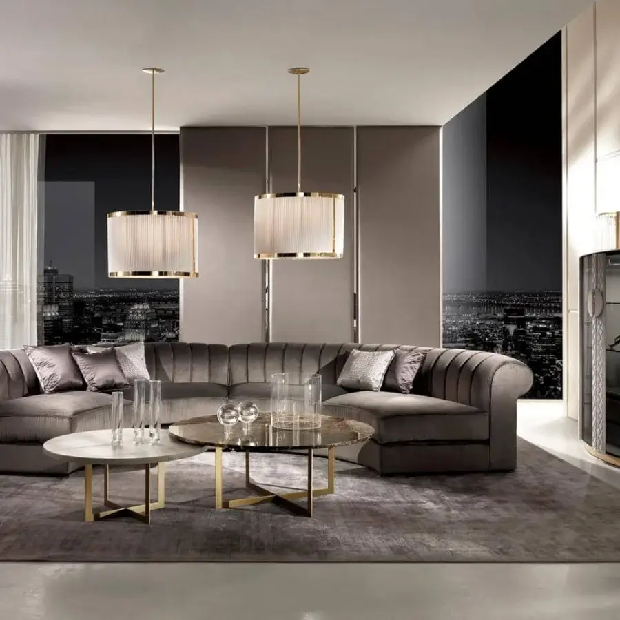 Exquisite DV Home Collection sofa upholstered in smooth gray-brown textile with vertical tufting and a sleek hidden chrome base
