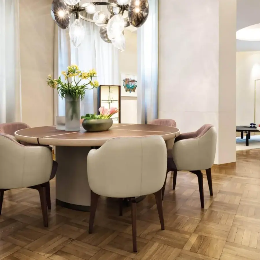 Distinguished Giorgetti Gordon table with a round wooden tabletop, saddle leather base and bronze painted details showcasing maple dividers