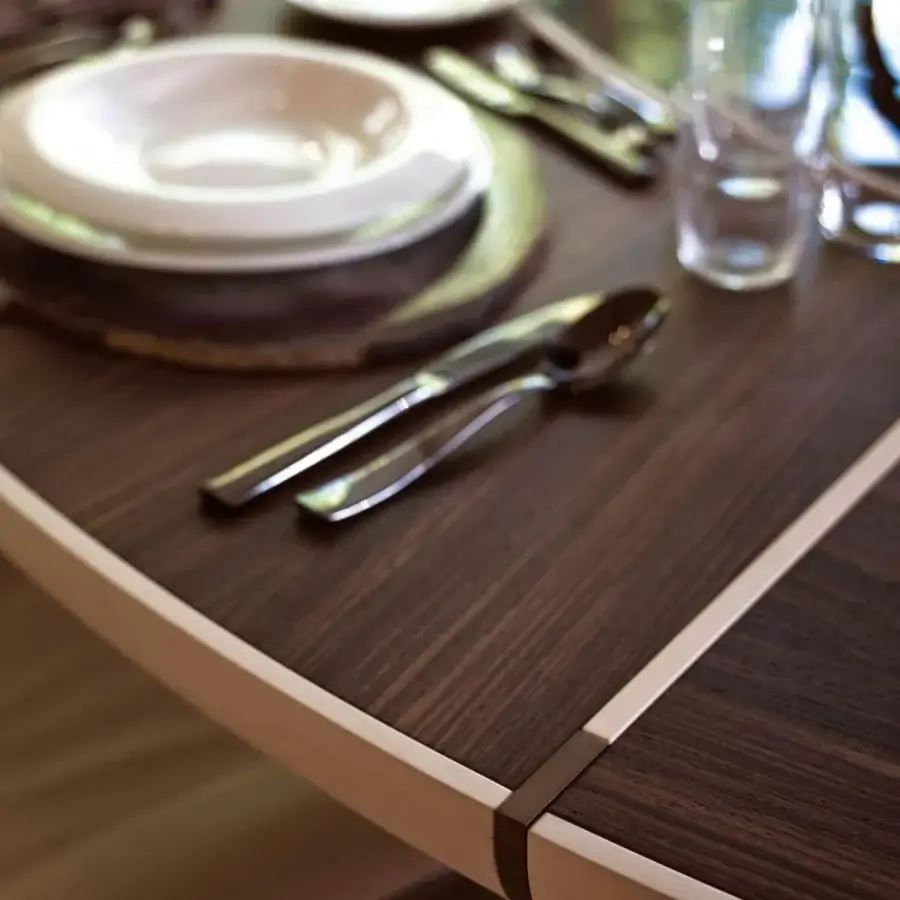 Elegant Giorgetti Gordon table with dark wood and a lighter frame complemented by bronze painted details