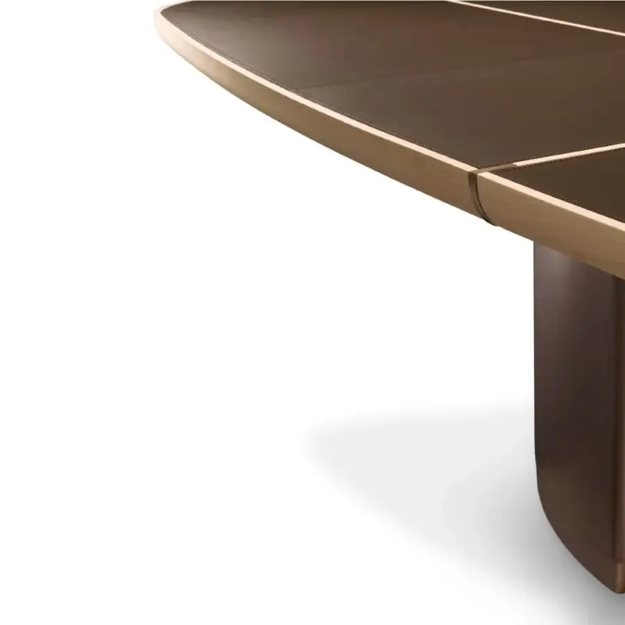 Captivating Giorgetti Gordon table with shaped maple top, brown saddle leather inserts and bronze painted details