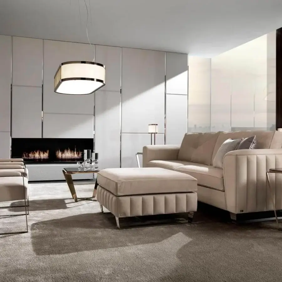 Handcrafted DV Home Collection Beverly ottoman with plush beige fabric upholstery and sleek chrome-like metal frame