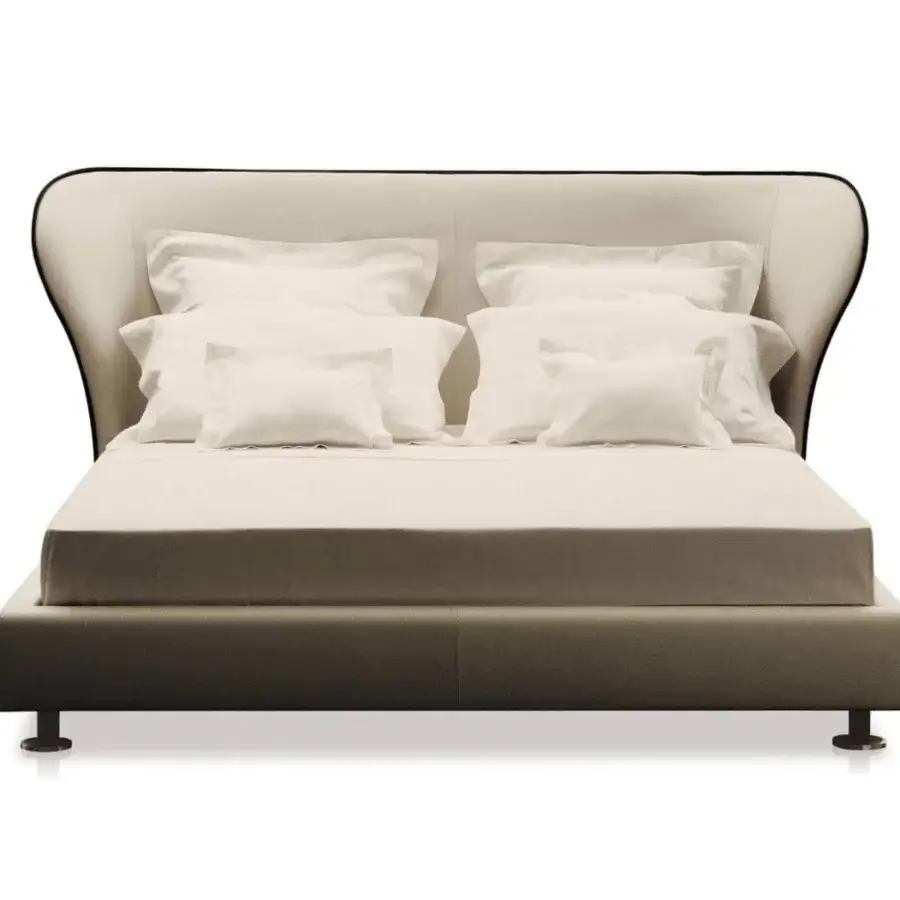 Distinctive Giorgetti Rea bed with winged headboard upholstered in light beige fabric and polished pau ferro metal feet