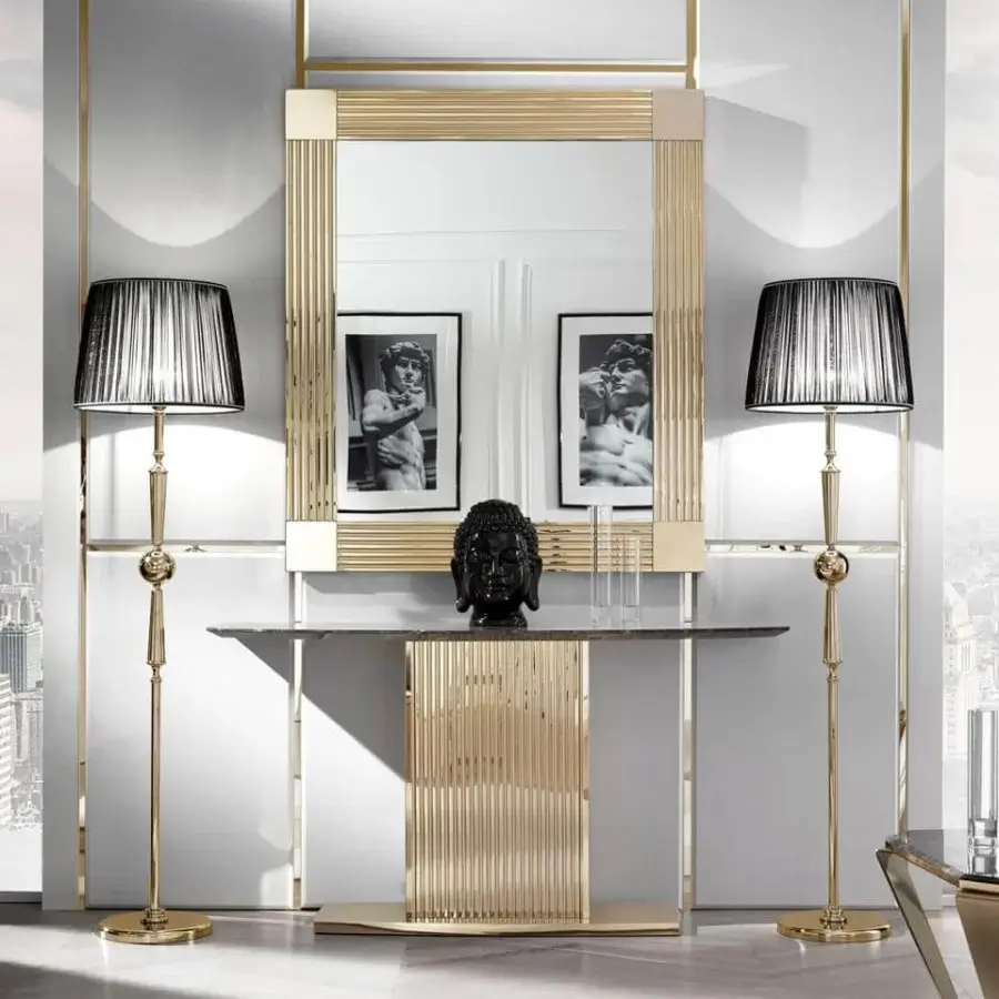Elegant DV Home Collection Windsor console with a dark stone-like top and glossy gold stainless steel base