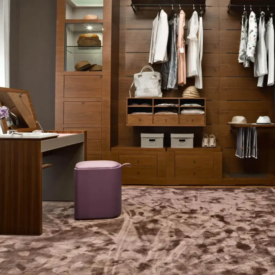 Elegant Giorgetti Venus ottoman upholstered in smooth purple fabric with a curved leather base and functional handle