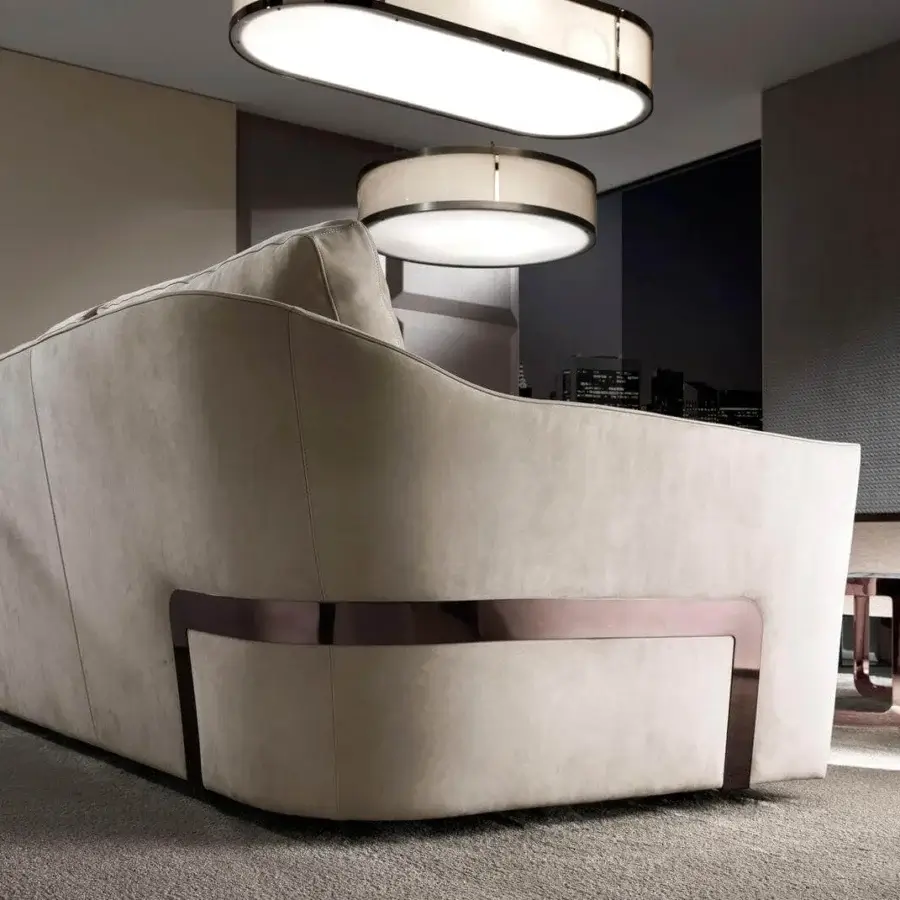 Elegant DV Home Collection Deco sofa upholstered in light beige textile with decorative stitching and a dark steel base