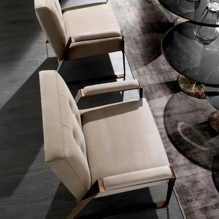 Distinguished DV Home Collection Deco lounge chair with light beige textile upholstery and bronze finished steel armrests and legs