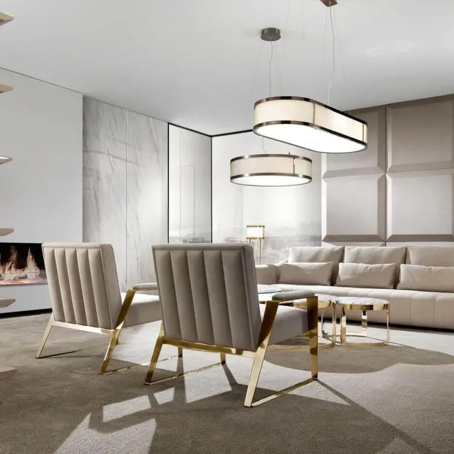 Elegant DV Home Collection Deco lounge chair with quilted taupe textile upholstery and gold-toned steel structure