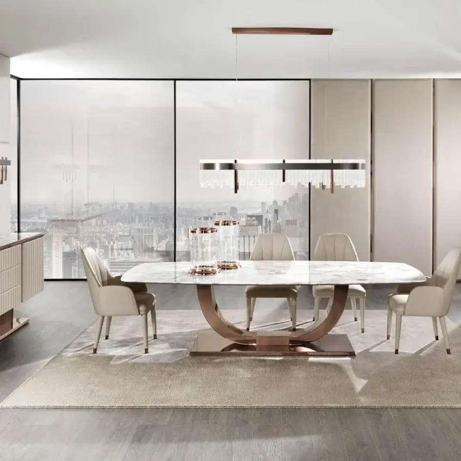 Elegant DV Home Collection Heritage table with a light greyish-white marble top and bronze U-shaped stainless steel base