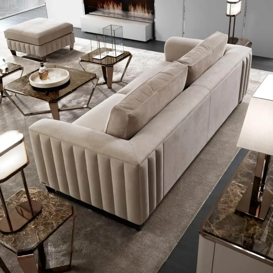 Lavish DV Home Collection Beverly sofa with plush fabric upholstery, vertical quilting and dark metal feet
