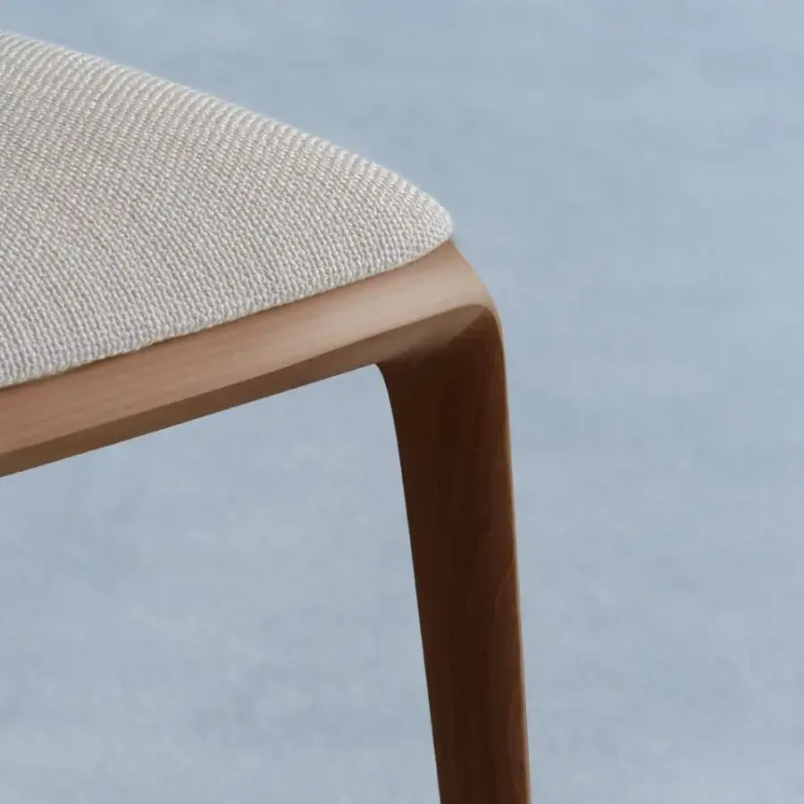 Distinguished Potocco Hiru chair crafted with light-toned ash wood and a light beige woven textile seat with a smooth finish