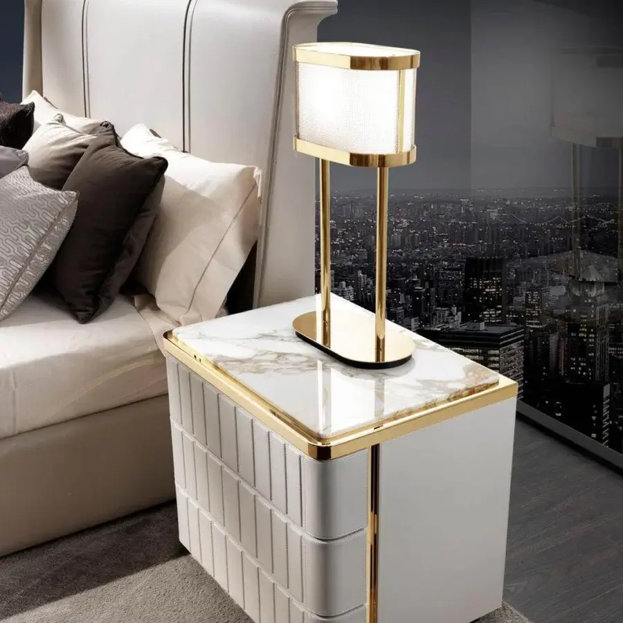 Exclusive DV Home Collection Elite nightstand crafted with white leather and a marble-like top with gold-toned stainless steel accents