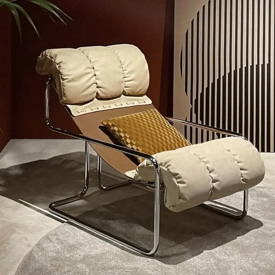 Distinguished 4 Mariani Tucroma lounge chair with light beige cushions and rich brown saddle leather built with a polished steel frame