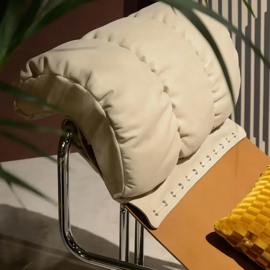 Innovative 4 Mariani Tucroma lounge chair with tan leather and textured yellow cushioning in a shiny steel frame