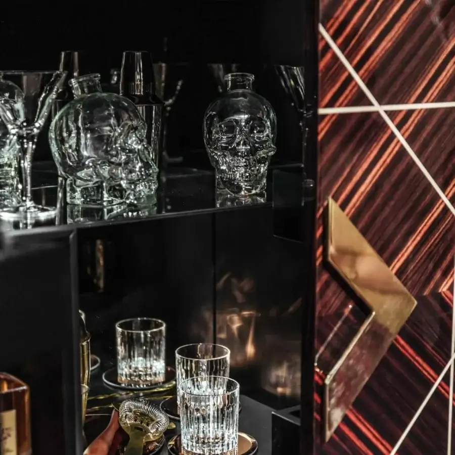 Superior Vismara Spirit bar cabinet crafted with Ebony Makassar, maple wood inlay, and glossy brass handles with mirrored interior lighting
