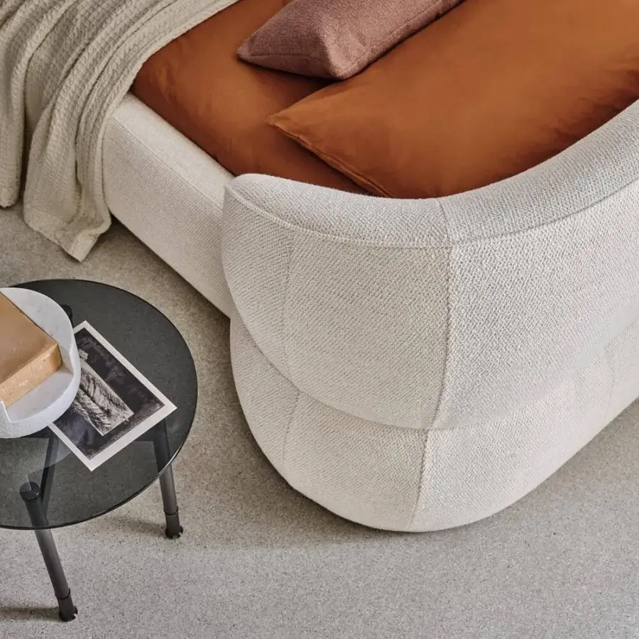 Sophisticated Ditre Italia Clip bed with curved headboard and padded base upholstered in textured off-white textile with matte finish