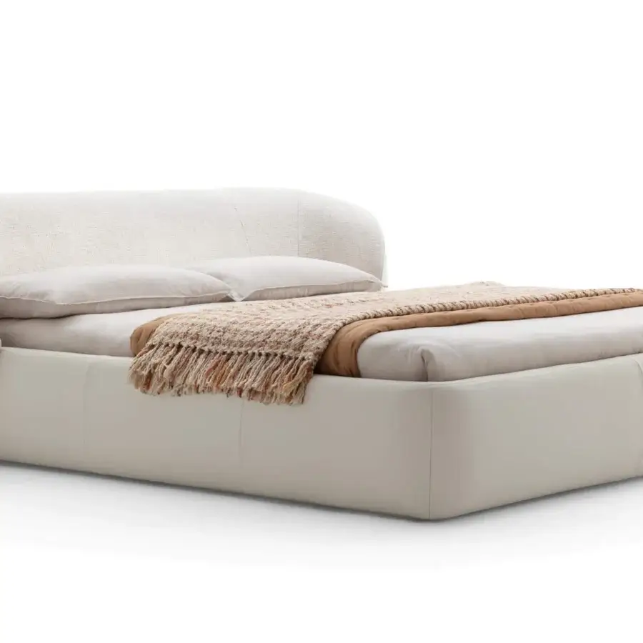 Sophisticated Ditre Italia Clip bed with curved headboard and padded base upholstered in refined fabrics with smooth frame