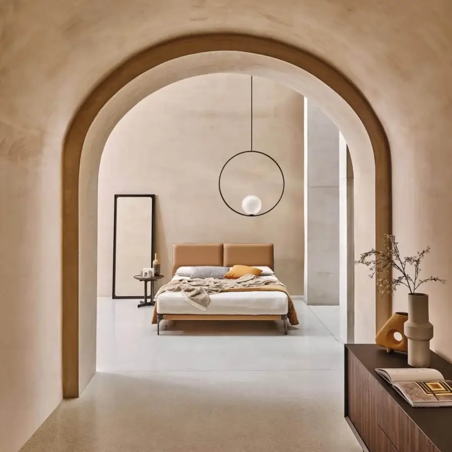 Superior Ditre Italia Ada bed with a low profile and slimline headboard upholstered in smooth tan material with a dark metal frame